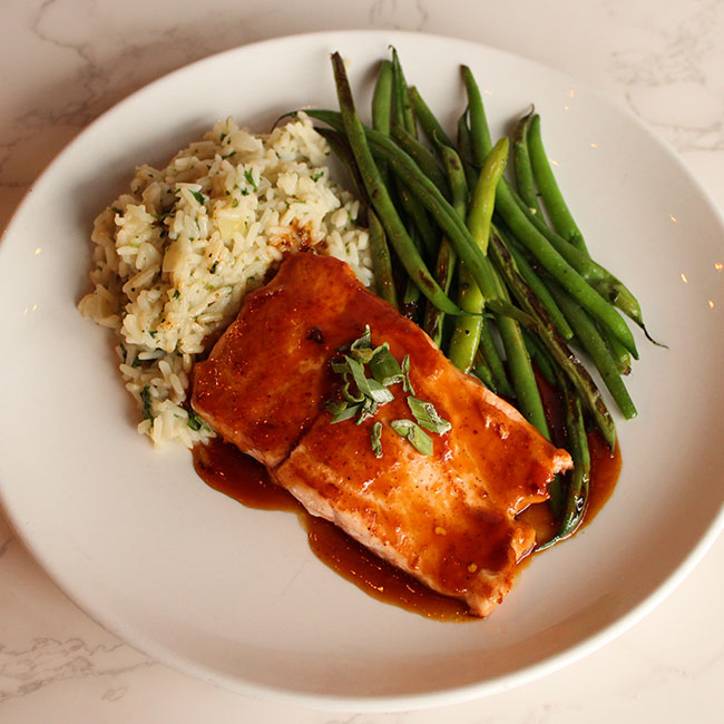 Glazed topped salmon and sides of crispy green beans and rice for Pennsylvania wedding event by Collective Brands Catering.